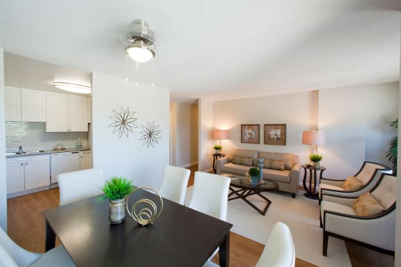a living room and dining room with a table and chairs