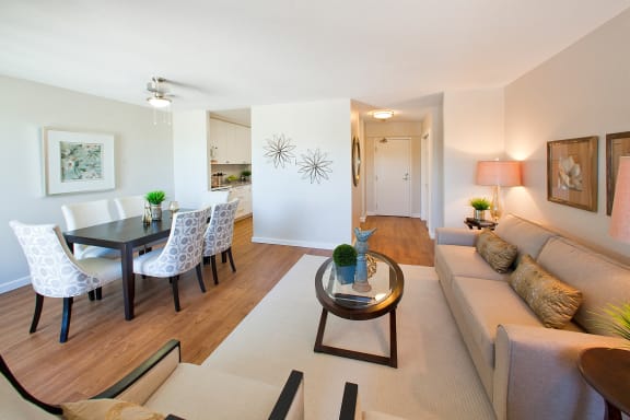 a living room and dining room area with a couch and a table