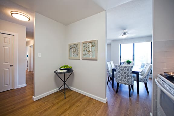 a living room and dining room with a table and chairs and a window