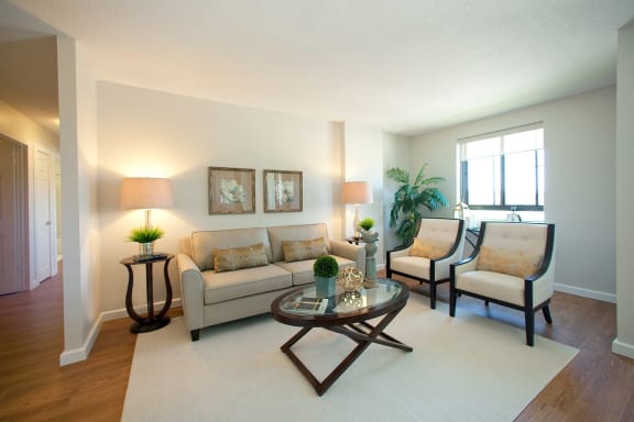 a living room with a couch and chairs and a table