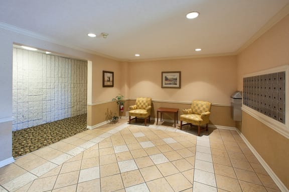 a waiting room with chairs and a table in a lobby