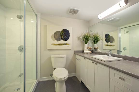 a bathroom with a toilet and a sink and a shower