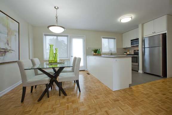 a kitchen and dining room with a table and chairs