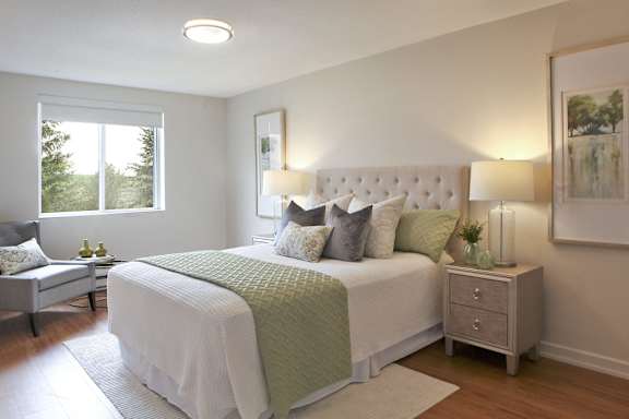 a bedroom with a large bed and a window