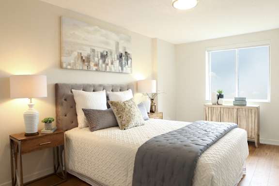 a bedroom with a bed and a painting on the wall
