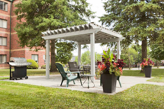 a patio with a table and chairs under a pavilion