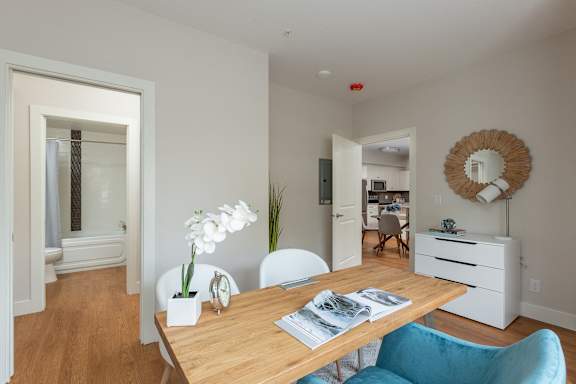 a dining room with a wooden table and blue chairs