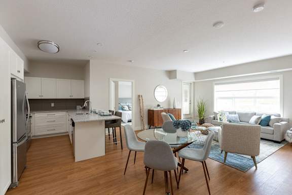 an open living room and kitchen with a dining room table and chairs