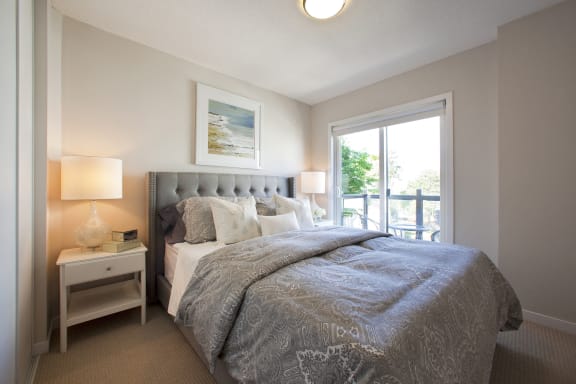 a bedroom with a large bed and a window