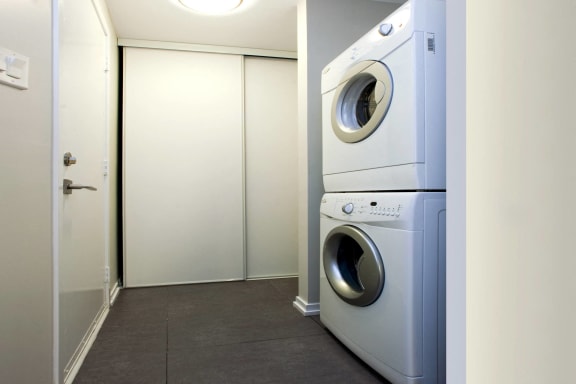 a front loading washer and dryer in a laundry room