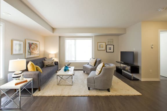 a living room with a couch and chairs and a television