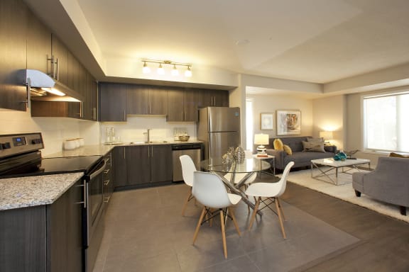 a kitchen and living room with a table and chairs
