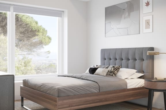 a bedroom with a bed and a large window