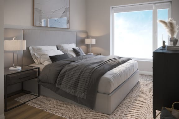 a bedroom with a bed and a large window