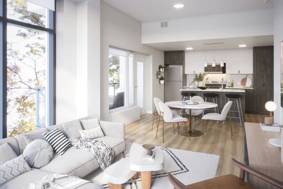a living room with a couch and a table and a kitchen