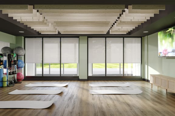 a yoga room with yoga mats on the floor and a staircase
