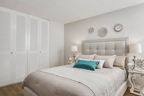 a bedroom with a bed and pillows