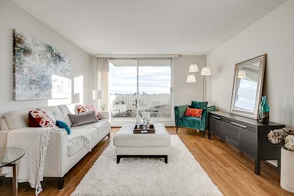 a living room with a white couch and a large window