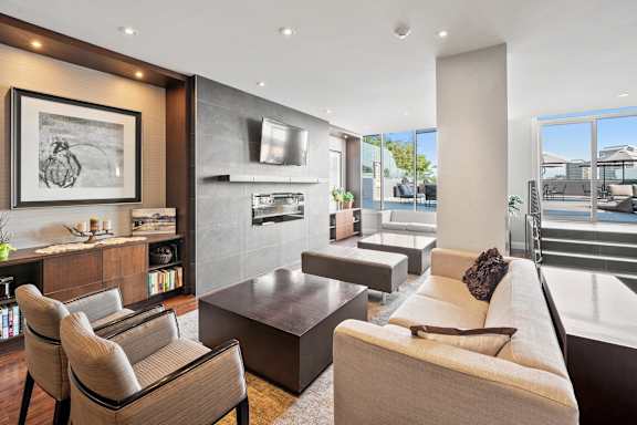 a living room with a couch and chairs and a fireplace