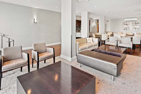 a living room with couches and chairs and a table
