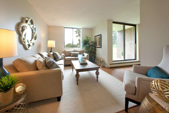 a living room with couches and chairs and a table