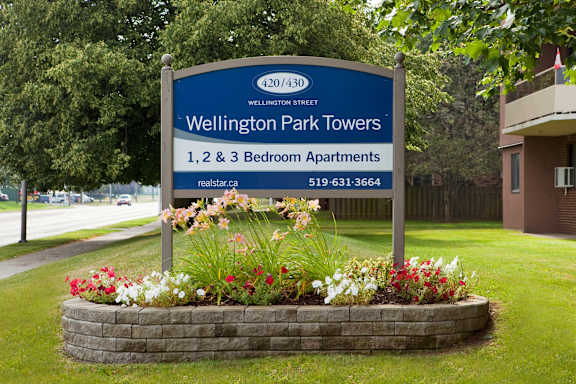 a sign park towers in front of a garden