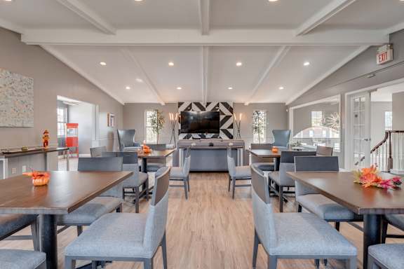 A modern dining room with a long table set for six.