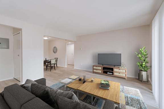 A living room with a grey sofa and a wooden coffee table.
