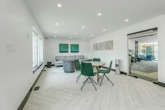 A white room with a table and chairs.