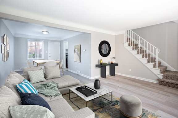 A living room with a grey couch and a coffee table.