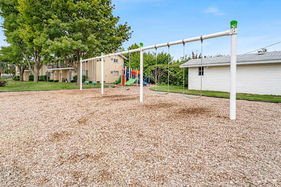 A playground with a swing set and a slide.
