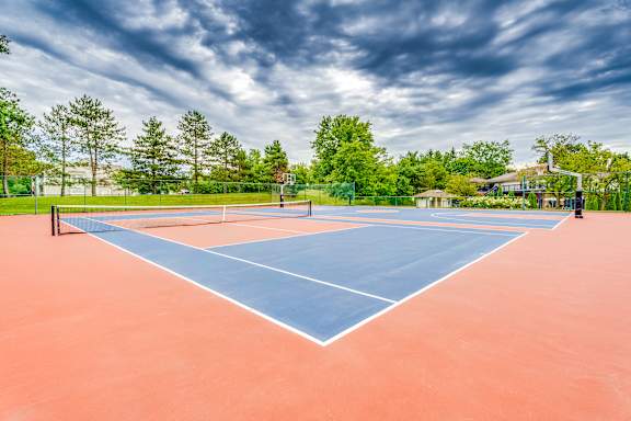 A tennis court with a blue line in the middle of it.