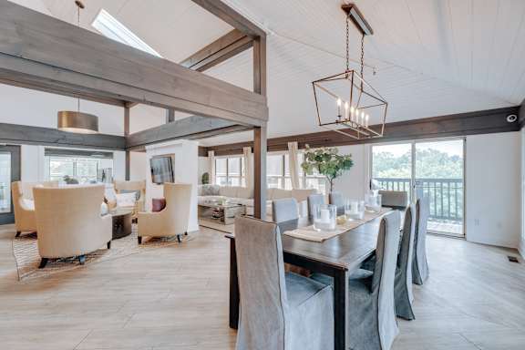 A modern dining room with a long table and chairs.