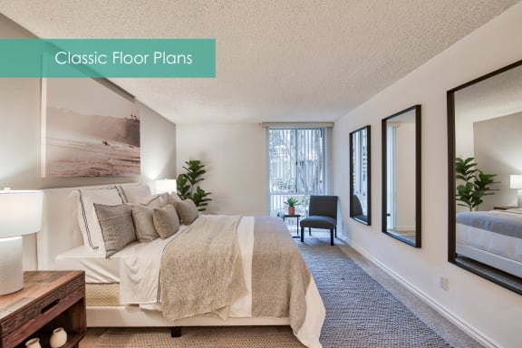 a master bedroom with a large bed and a window at The Meadows Apartments, Culver City , CA 90230