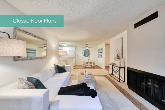 a living room with a white couch and a fireplace at The Meadows Apartments, Culver City , CA 90230