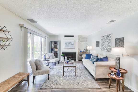 a living room with a couch and chairs and a fireplace  at Mediterranean Village Costa Mesa, Costa Mesa, 92626