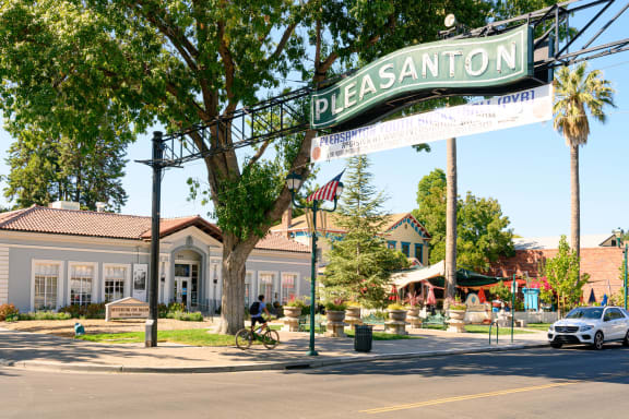 a street sign for pleasanton in front of a building at Pleasanton Place, Pleasanton, CA