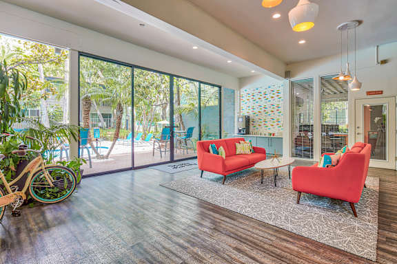 a living room with a couch and chairs and a patio