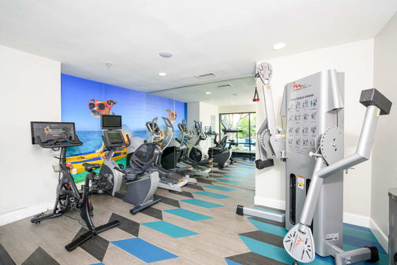 a gym with various cardio machines and a water fountain at Sendero Huntington Beach, Huntington Beach California