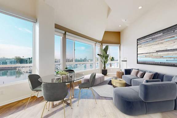 A modern living room with a view of a marina.