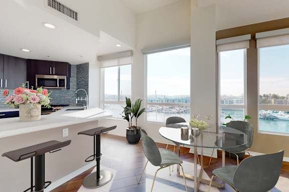 A modern kitchen with a bar area and a dining table set up.