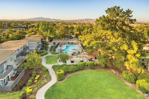 a aerial view of a yard with a pool and buildings