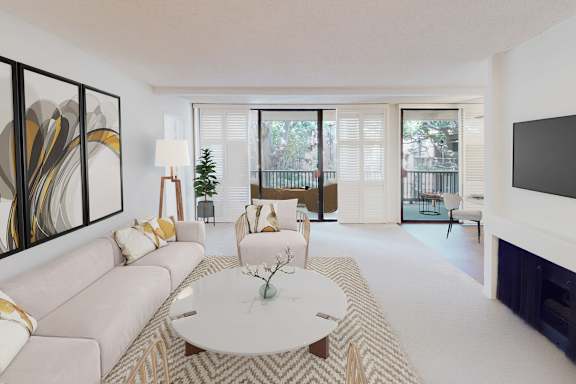 A living room with a white couch, a coffee table, and a painting on the wall.