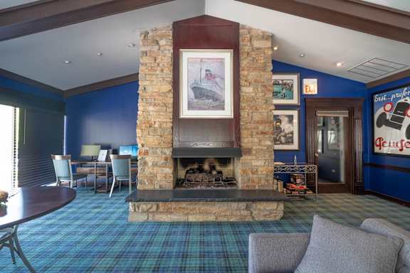 A room with a fireplace and a painting above it.