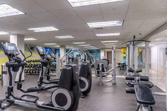 A gym with treadmills, exercise bikes, and other equipment.