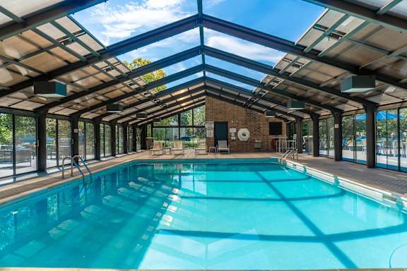 A large indoor swimming pool with a glass ceiling.
