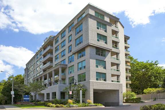 an apartment building with a blue sky in the background
