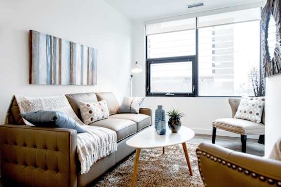 a living room with a couch and a table and a window