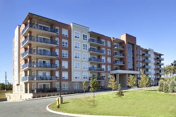 A large apartment building with a fire hydrant in front of it.