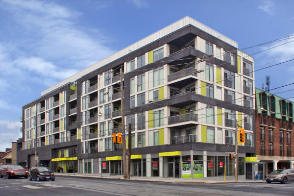 a large apartment building on the corner of a city street